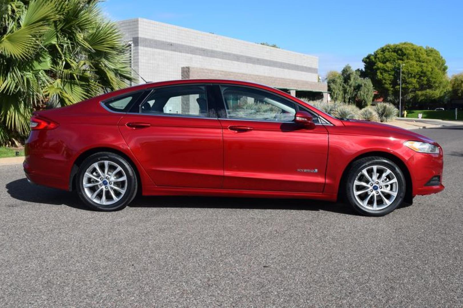 2017 Ruby Red Metallic Tinted Clearcoat /Medium Light Stone Ford Fusion Hybrid SE (3FA6P0LU2HR) with an 2.0L L4 DOHC 16V HYBRID engine, CVT transmission, located at 11056 N 23rd Dr #101, Phoenix, AZ, 85029, (623) 434-4252, 33.587704, -112.109962 - Photo#3