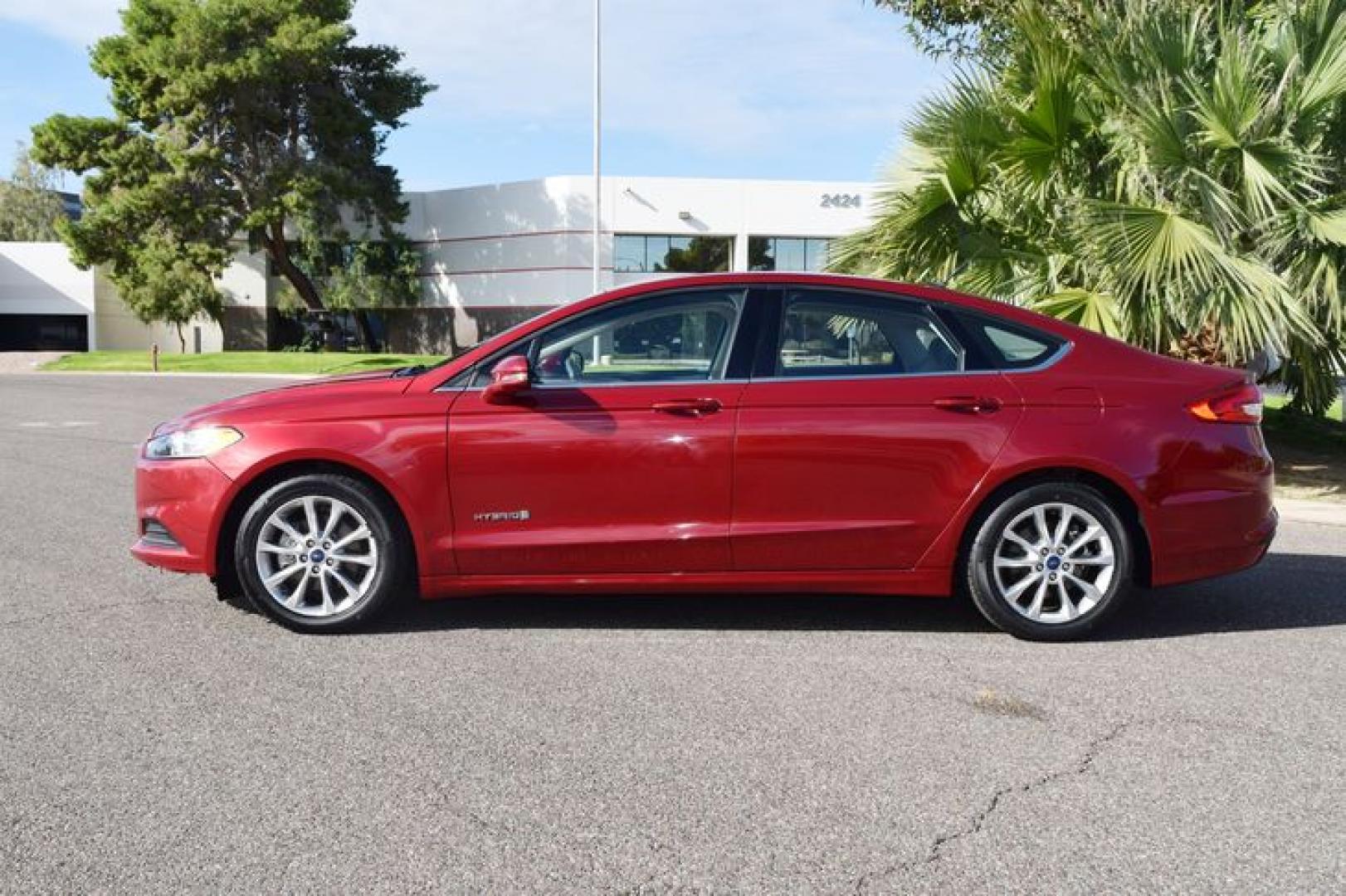 2017 Ruby Red Metallic Tinted Clearcoat /Medium Light Stone Ford Fusion Hybrid SE (3FA6P0LU2HR) with an 2.0L L4 DOHC 16V HYBRID engine, CVT transmission, located at 11056 N 23rd Dr #101, Phoenix, AZ, 85029, (623) 434-4252, 33.587704, -112.109962 - Photo#4
