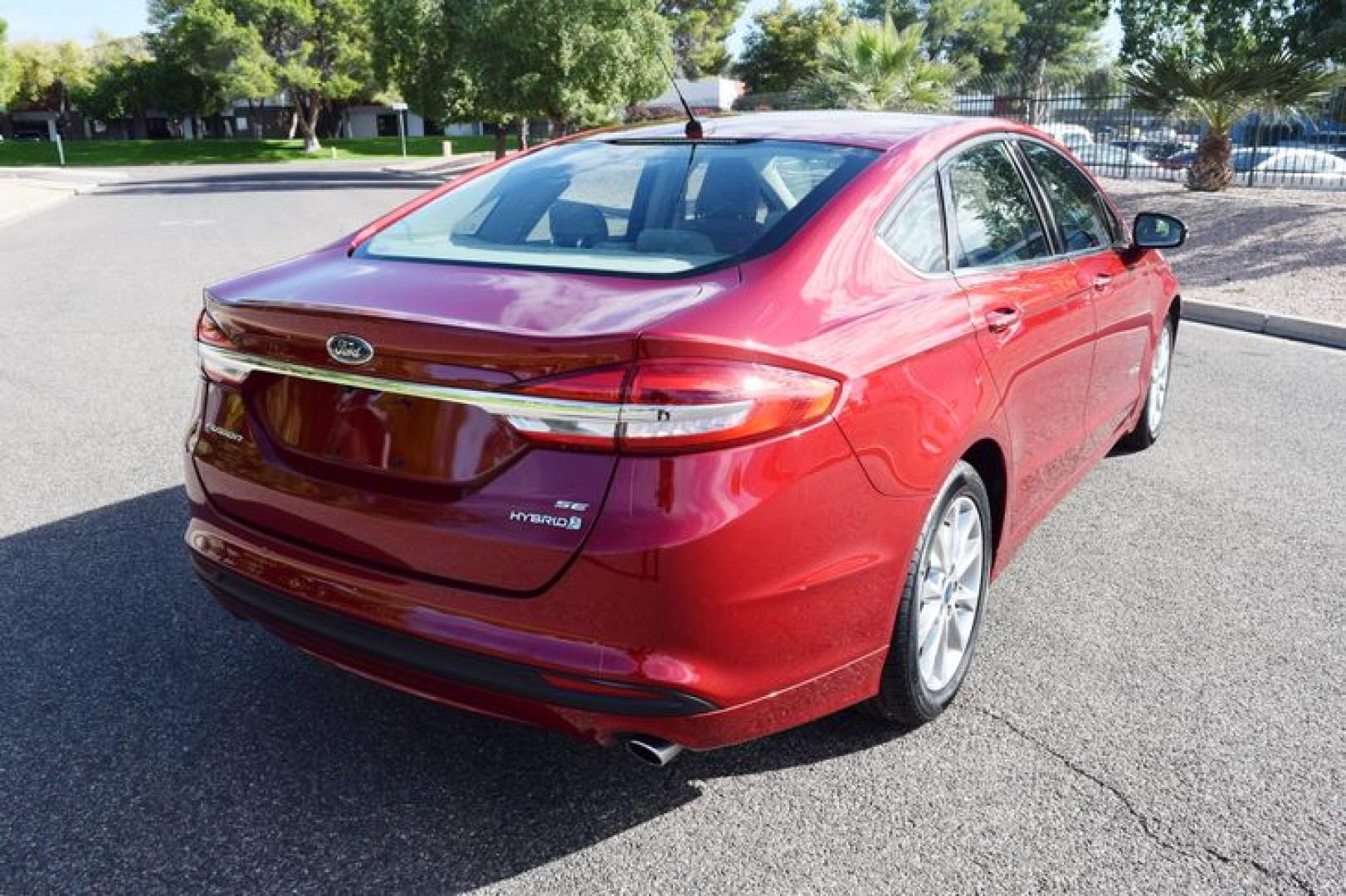 2017 Ruby Red Metallic Tinted Clearcoat /Medium Light Stone Ford Fusion Hybrid SE (3FA6P0LU2HR) with an 2.0L L4 DOHC 16V HYBRID engine, CVT transmission, located at 11056 N 23rd Dr #101, Phoenix, AZ, 85029, (623) 434-4252, 33.587704, -112.109962 - Photo#5